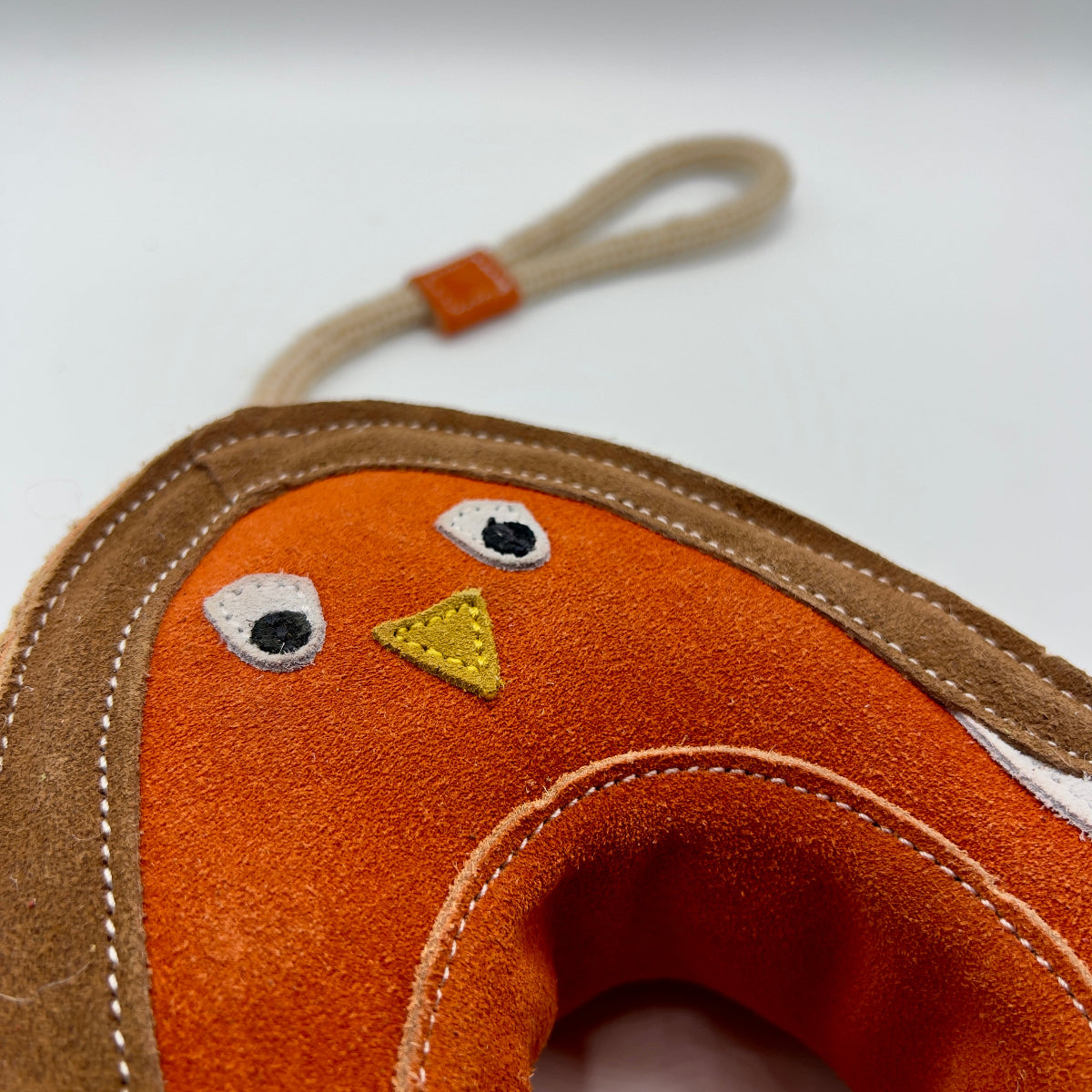 Dog toy shaped like a robin bird with a rope