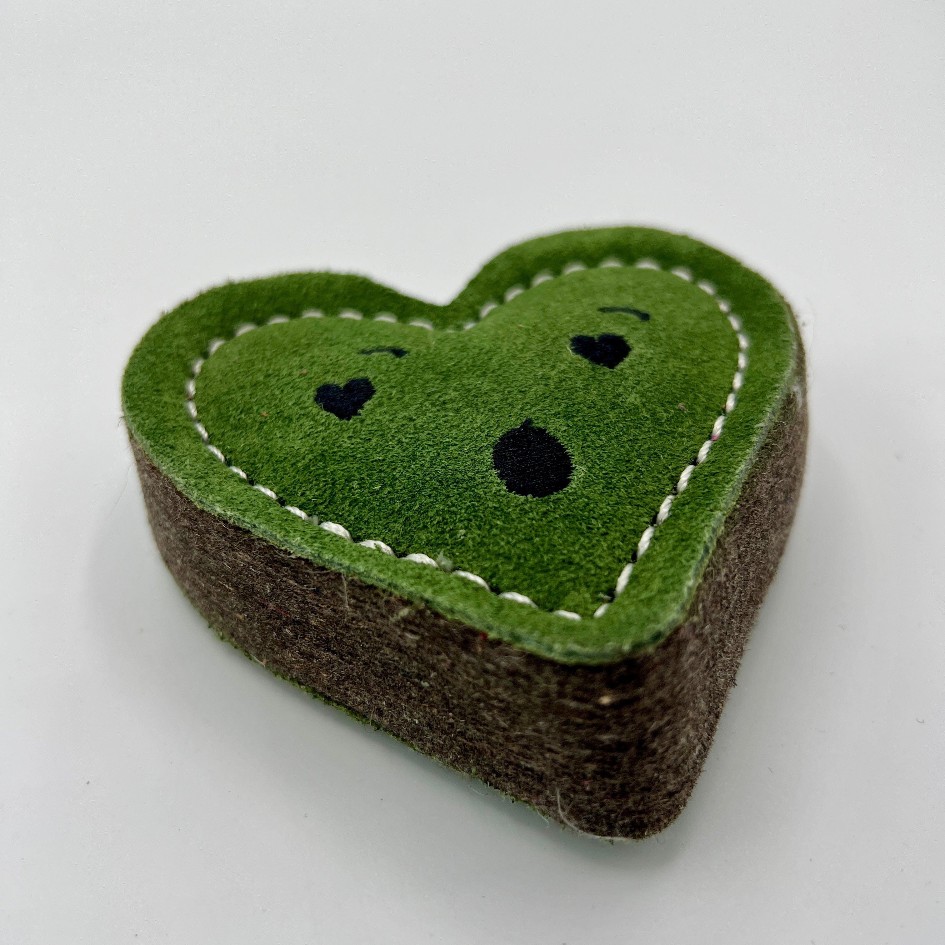 Heart-shaped green eco friendly dog toy with a surprised face
