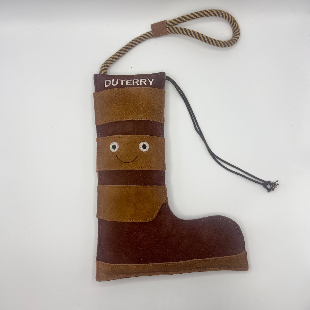 Brown boot-shaped dog toy with 'Duterry' written on it from green and wilds