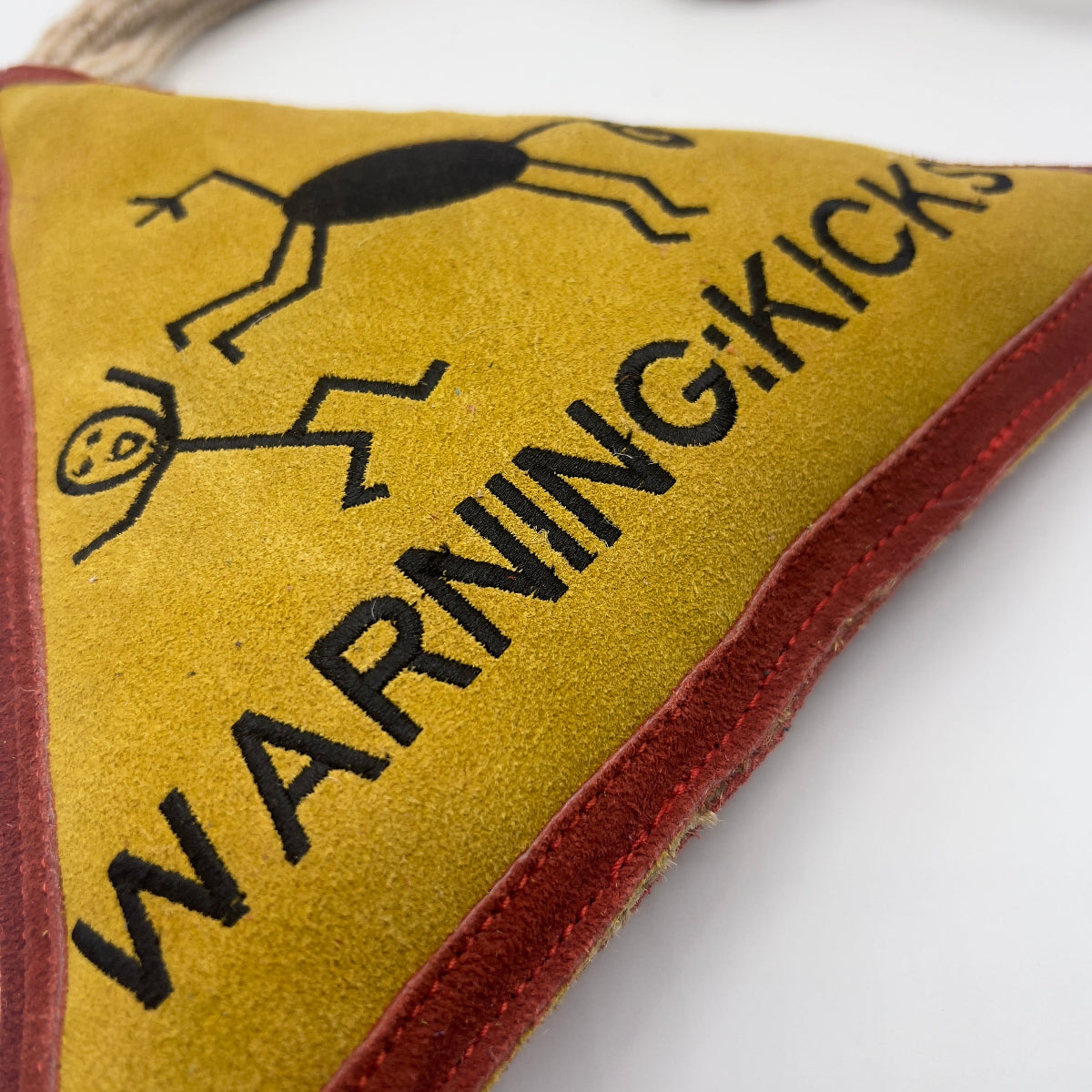 Triangle-shaped horse and dog toy with 'Warning Kicks!' warning sign and rope