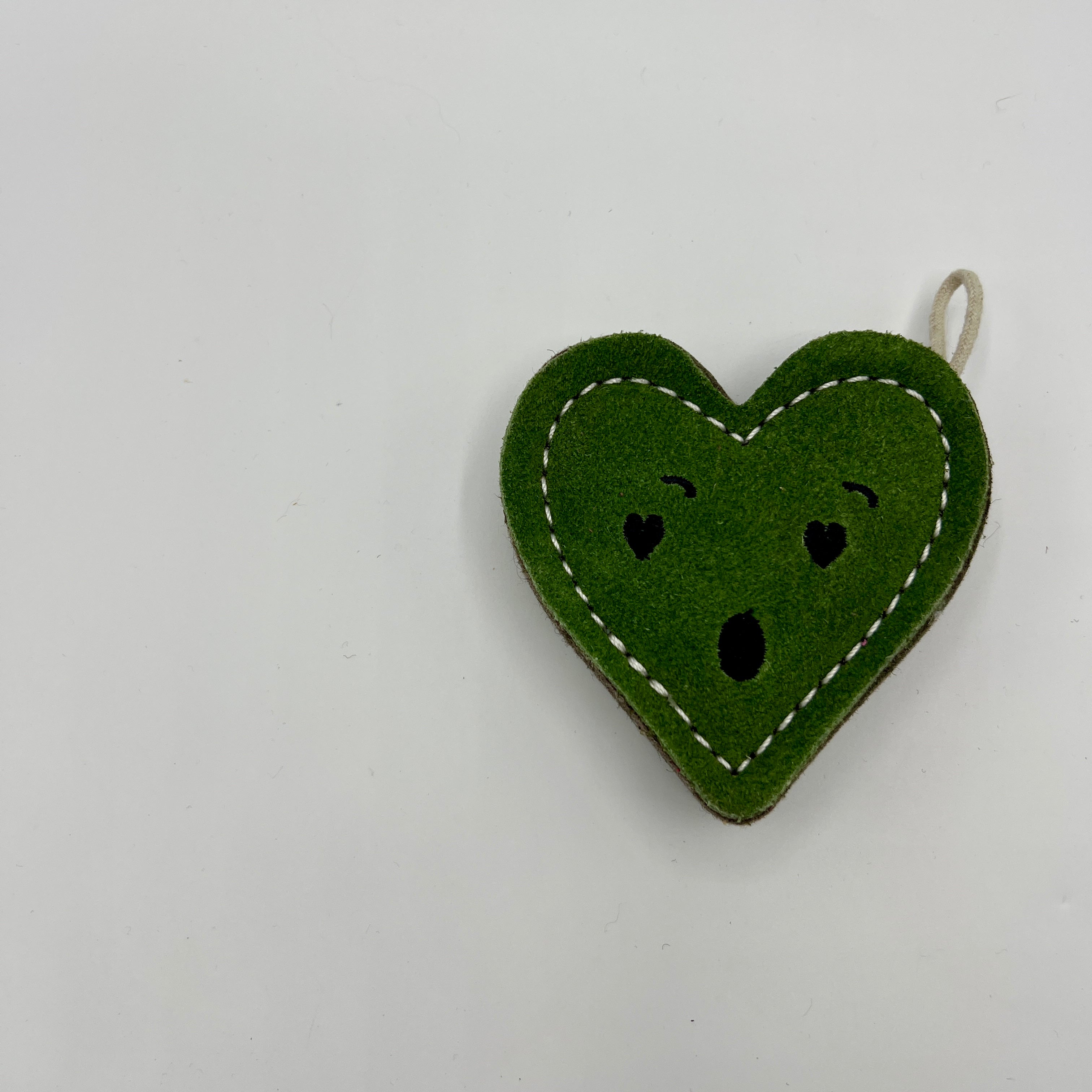 Heart-shaped green eco friendly dog toy with a surprised face