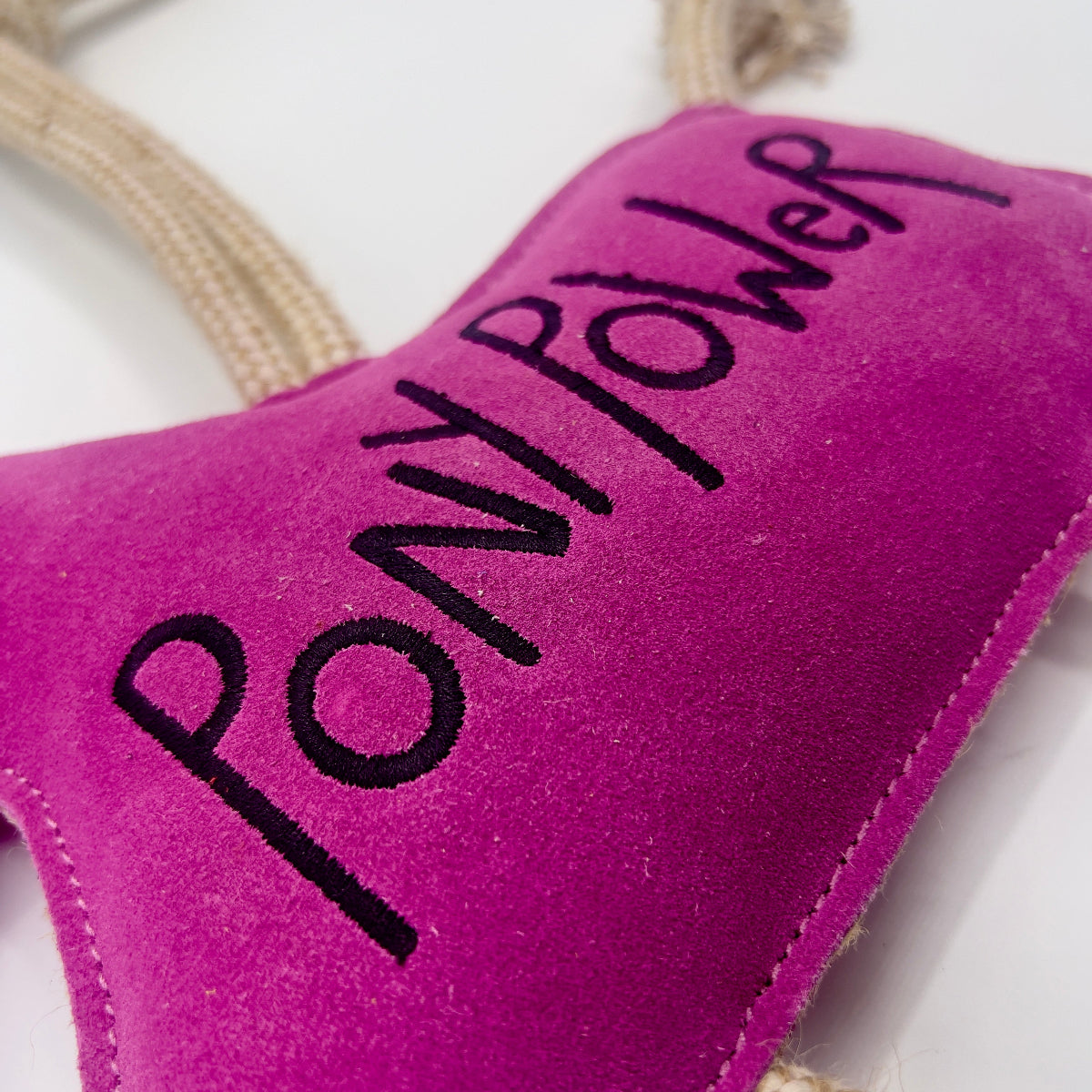 Pink horse-shaped horse and dog toy with 'PONY POWER' text and a rope from green and wilds