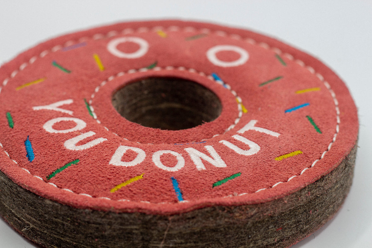 donut-shaped dog toy with 'You Donut' text and colorful sprinkles