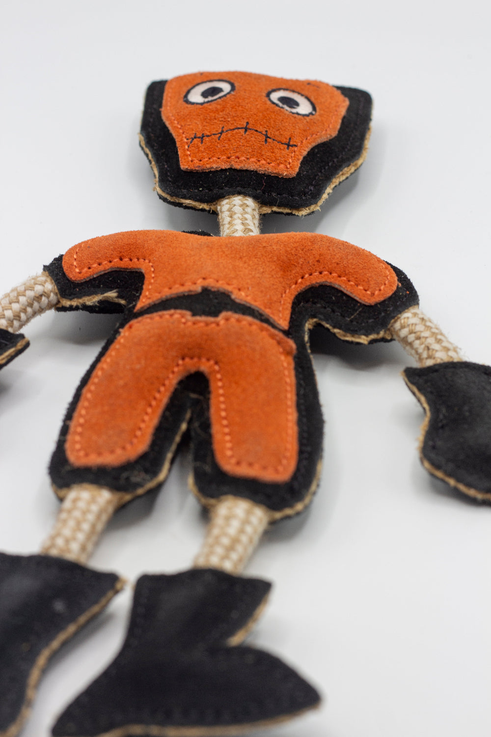 Halloween dog toy resembling an orange and black monster