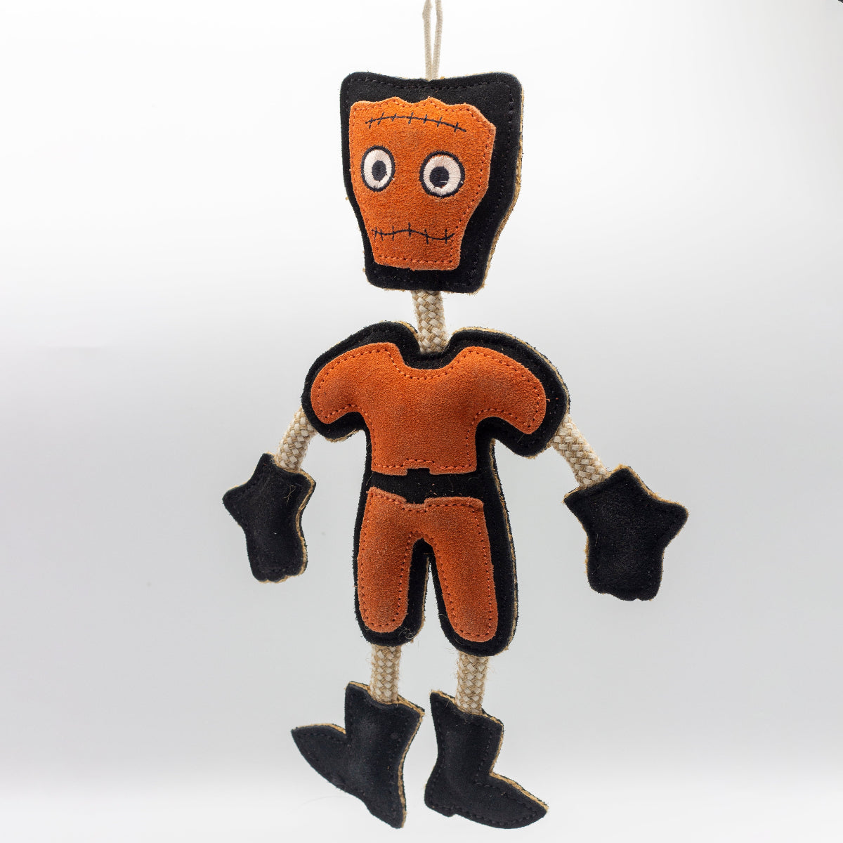 Halloween dog toy resembling an orange and black monster