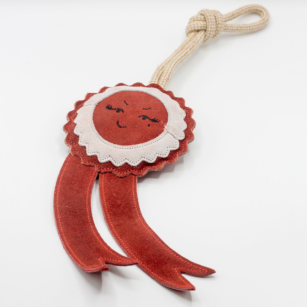 Green and wilds dog toy shaped as a red rosette