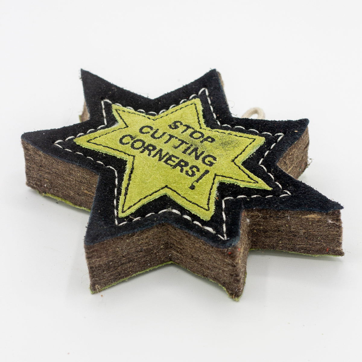 Star-shaped patch dog toy with 'Stop Cutting Corners!' text on it