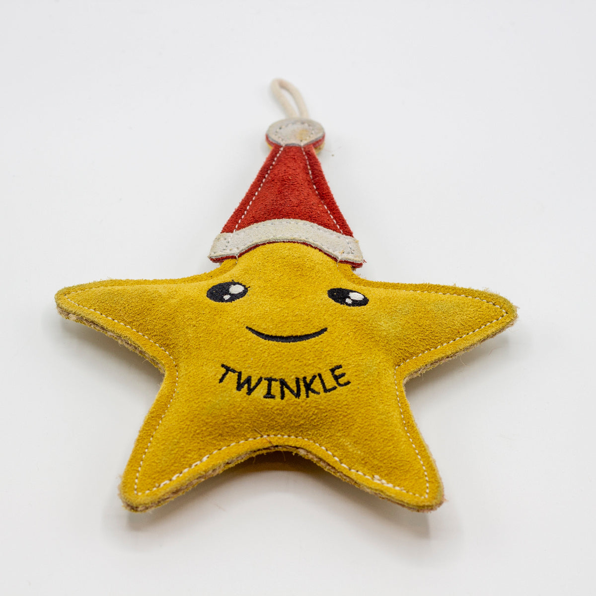 Star-shaped Christmas dog toy with a red Santa hat and 'Twinkle' text on a white background