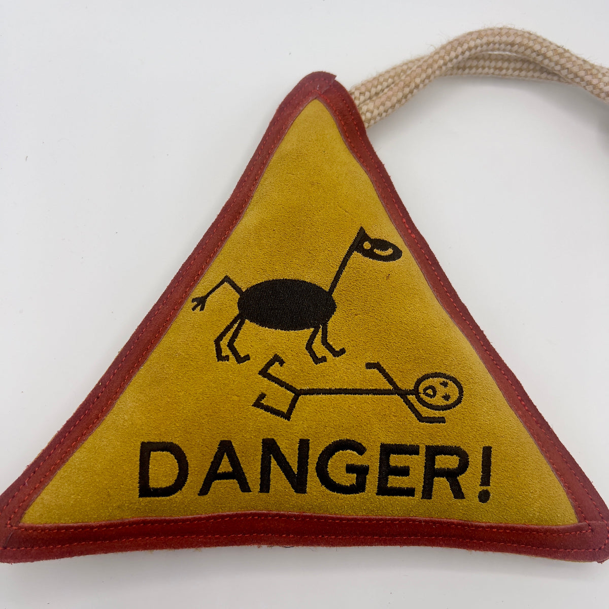 Triangle-shaped horse and dog toy with 'Danger!' warning sign and rope