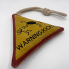 Triangle-shaped horse and dog toy with 'Warning Kicks!' warning sign and rope