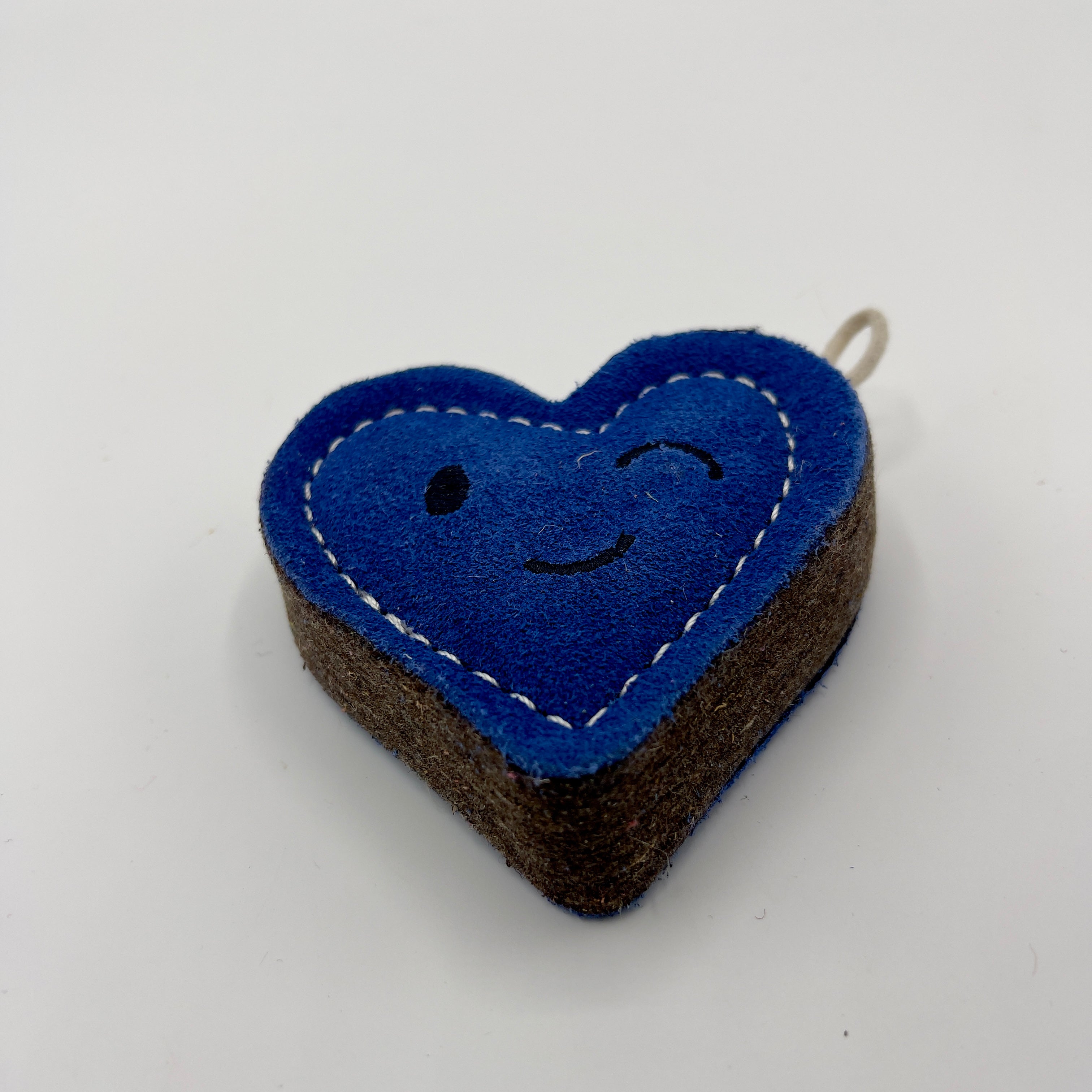 Heart-shaped blue eco friendly dog toy with a winky face