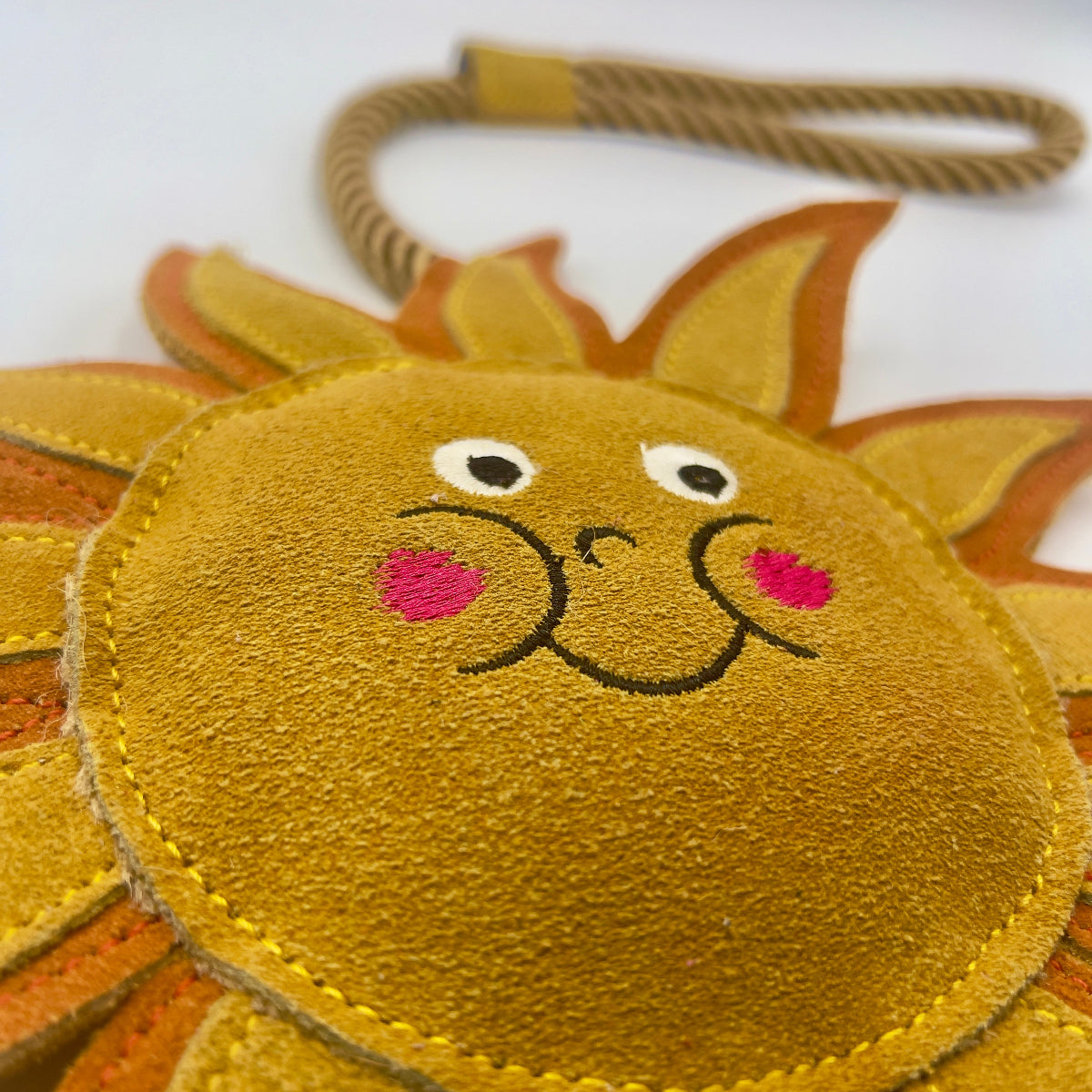 Sun-shaped dog and horse toy with a smiley face from Green and Wilds