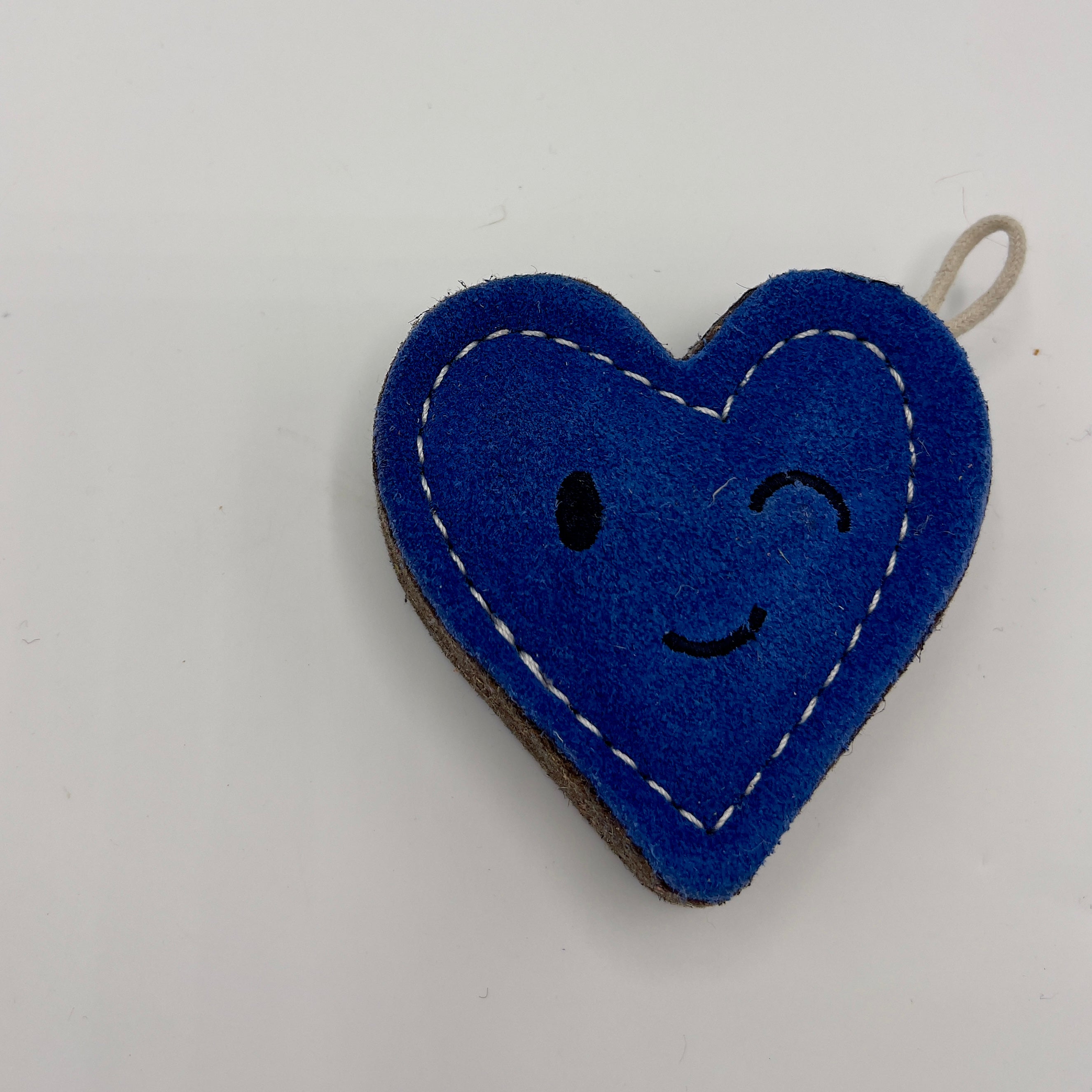 Heart-shaped blue eco friendly dog toy with a winky face