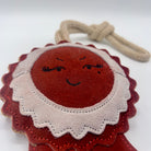 Green and wilds dog toy shaped as a red rosette