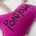 Pink horse-shaped horse and dog toy with 'PONY POWER' text and a rope from green and wilds