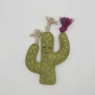 Green cactus-shaped dog toy with a smiling face