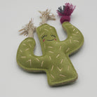 Green cactus-shaped dog toy with a smiling face