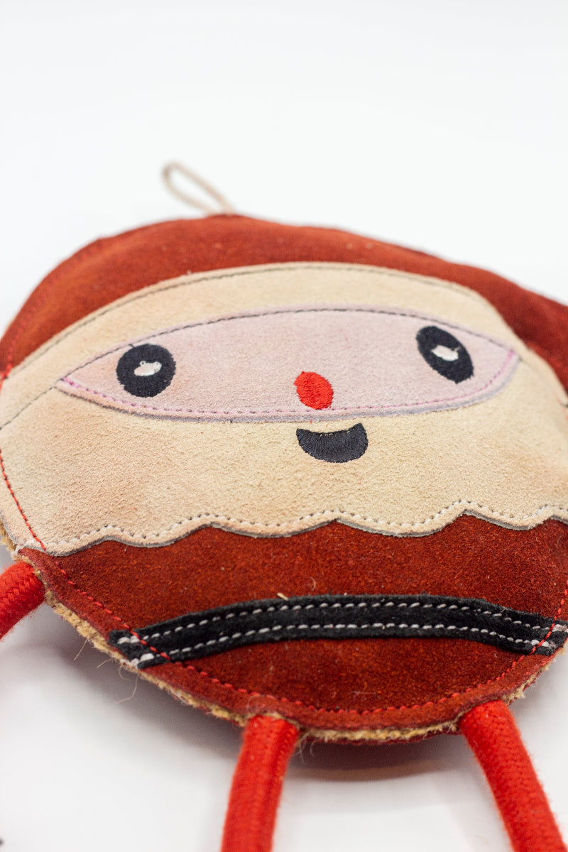 Christmas dog toy resembling the shape of a Santa