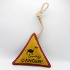 Triangle-shaped horse and dog toy with 'Danger!' warning sign and rope
