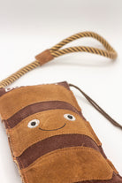 Brown boot-shaped dog toy with 'Duterry' written on it from green and wilds