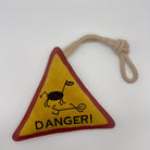Triangle-shaped horse and dog toy with 'Danger!' warning sign and rope