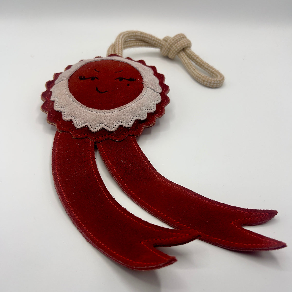 Green and wilds dog toy shaped as a red rosette