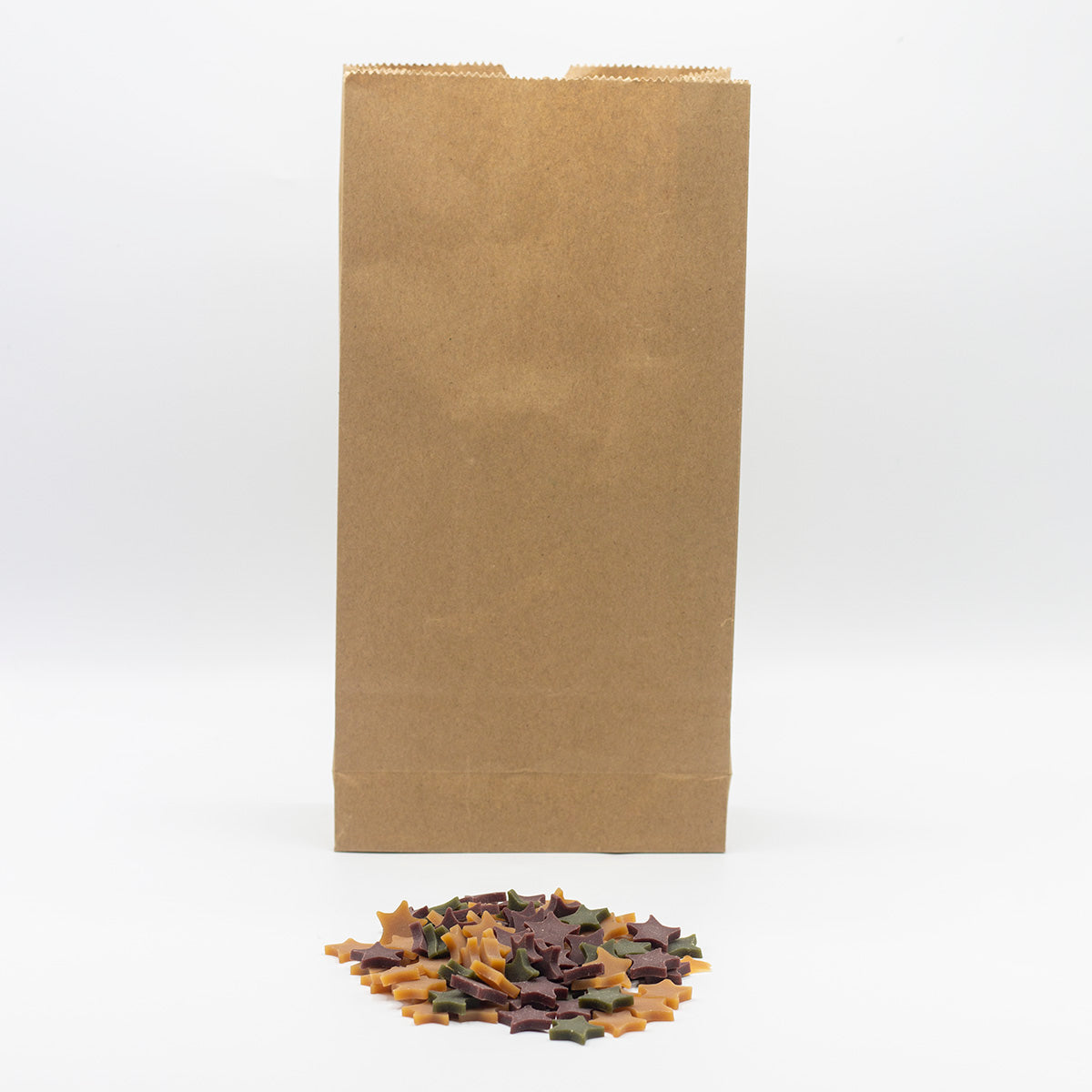 Dog treats shaped as stars in a paper bag