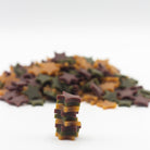 Dog treats shaped as stars in a paper bag