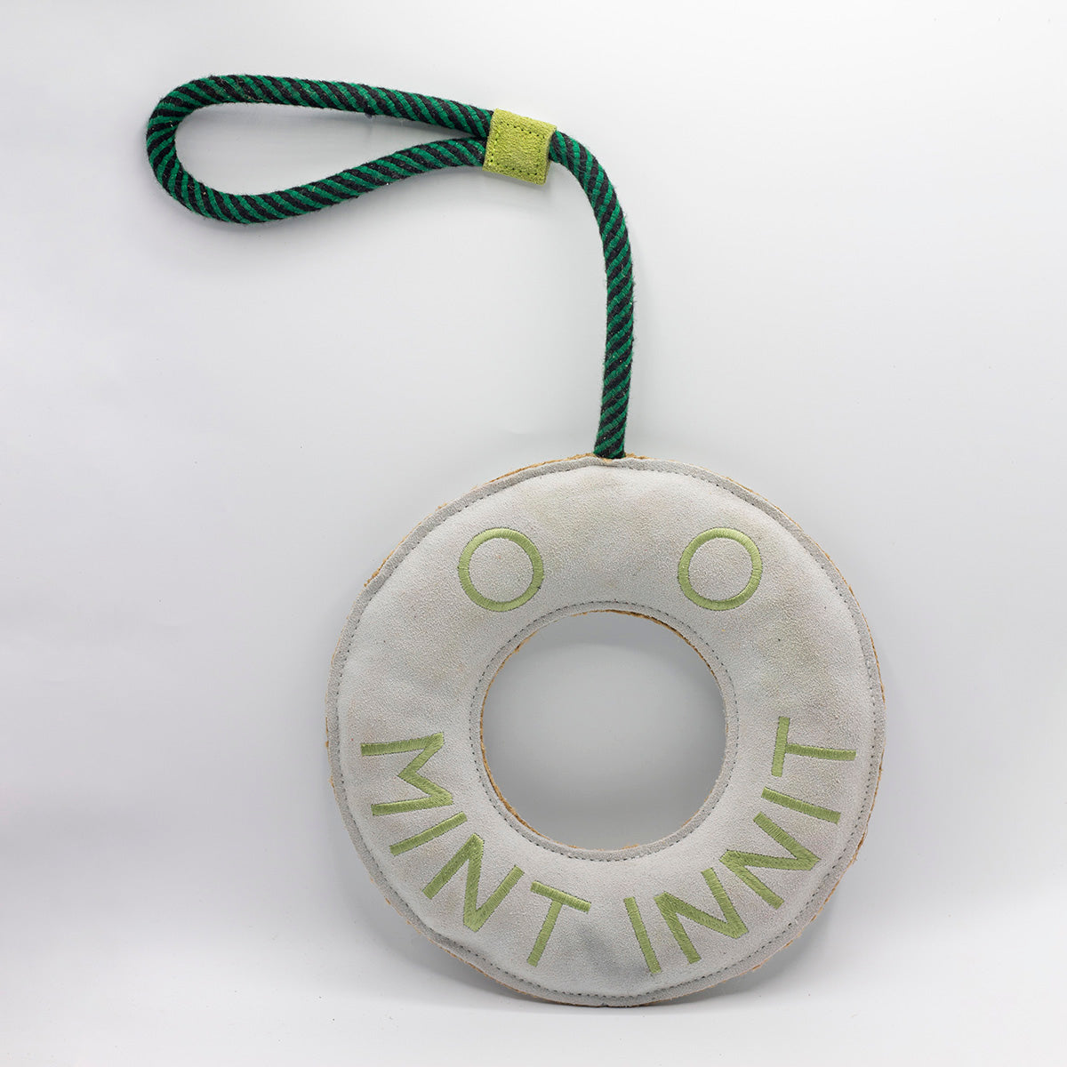 Round green and white dog toy with 'Mint Innit' text - green and wilds