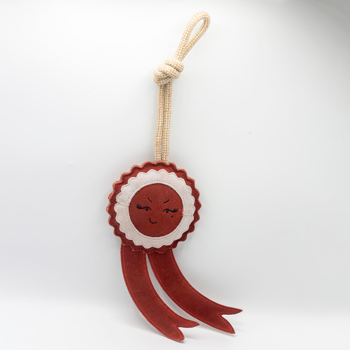 Green and wilds dog toy shaped as a red rosette