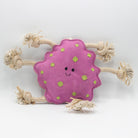 Pink suede dog toy with green spots and beige rope handles