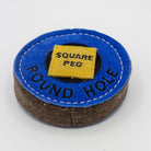 Blue circular dog toy labeled 'round hole' with a yellow square labeled 'Square Peg' inside