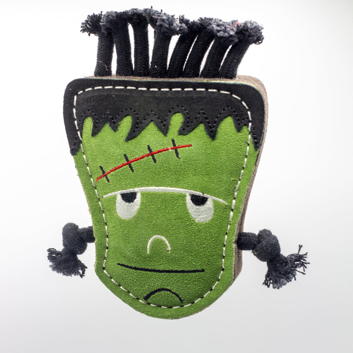 Halloween dog toy resembling a monster with black hair and stitch