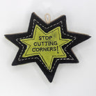 Star-shaped patch dog toy with 'Stop Cutting Corners!' text on it