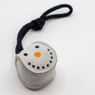 Small grey snowball-shaped Christmas dog toy with a black rope