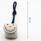 Small grey snowball-shaped Christmas dog toy with a black rope
