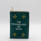 Book-shaped dog toy titled 'The Psychology of Cats'