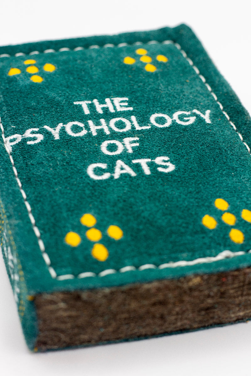 Book-shaped dog toy titled 'The Psychology of Cats'