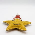 Star-shaped Christmas dog toy with a red Santa hat and 'Twinkle' text on a white background